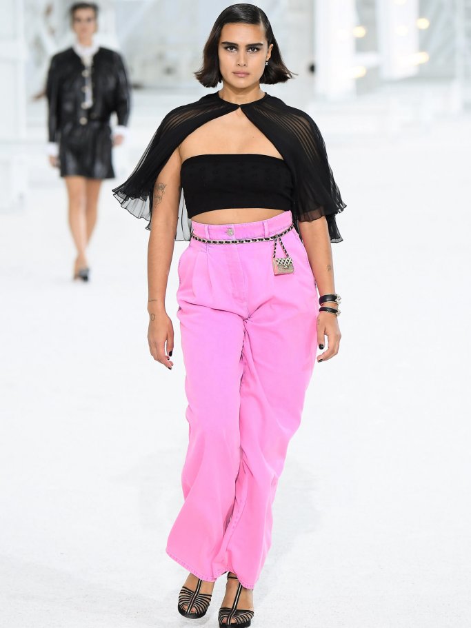 Model with curves on the catwalk with pink pants